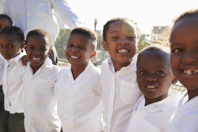 A group of smiling schoolchildren, Visionary Optics